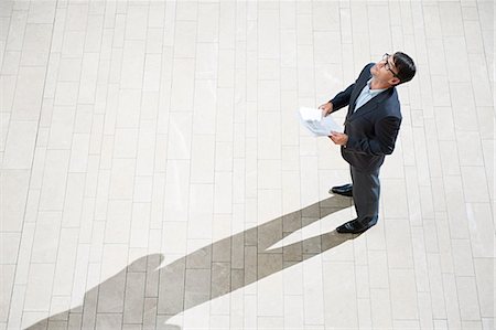 Businessman looking up Stock Photo - Premium Royalty-Free, Code: 614-03454784