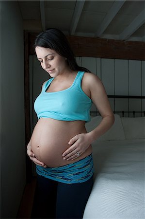 portrait of pregnant woman - Woman showing pregnancy bump Stock Photo - Premium Royalty-Free, Code: 614-03506436