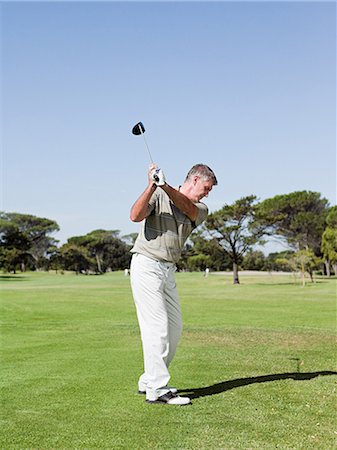 Man playing golf on golf course Stock Photo - Premium Royalty-Free, Code: 614-03506983
