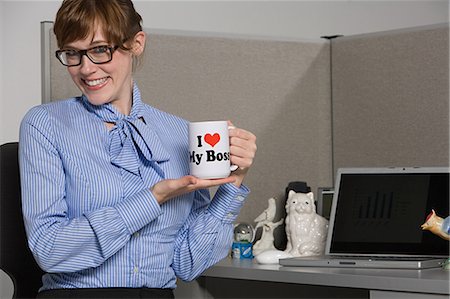 Businesswoman holding slogan mug Stock Photo - Premium Royalty-Free, Code: 614-03506999