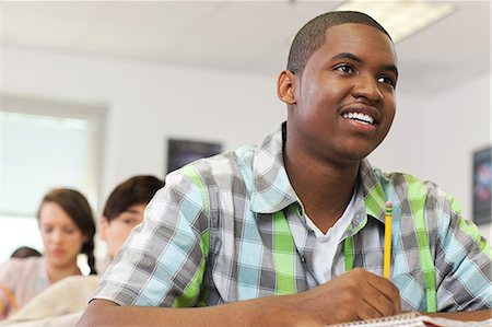 Male high school student working in classroom Stock Photo - Premium Royalty-Free, Code: 614-03551985