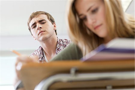 Male high school student copying classmate's work Stock Photo - Premium Royalty-Free, Code: 614-03551980