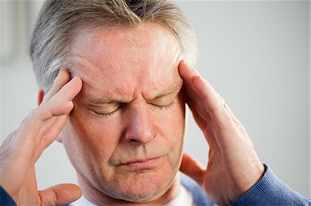 Man with a headache Stock Photo - Premium Royalty-Free, Code: 614-03552267