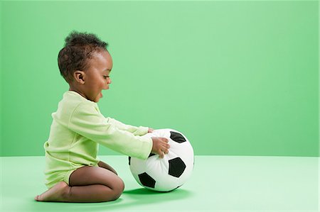 Baby boy playing with football Stock Photo - Premium Royalty-Free, Code: 614-03576681