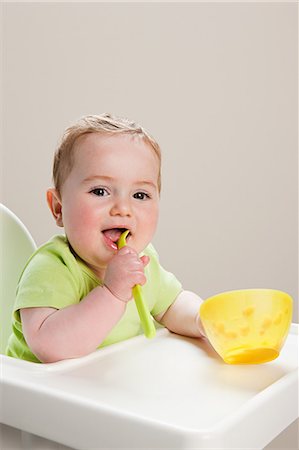 Baby boy with bowl of babyfood Stock Photo - Premium Royalty-Free, Code: 614-03576727