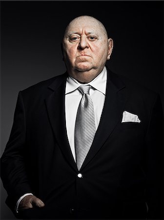 fat man - Studio portrait of serious gangster Stock Photo - Premium Royalty-Free, Code: 614-03647892