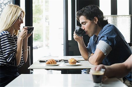 people eating at a coffee shop - Couple having coffee in cafe Stock Photo - Premium Royalty-Free, Code: 614-03649602