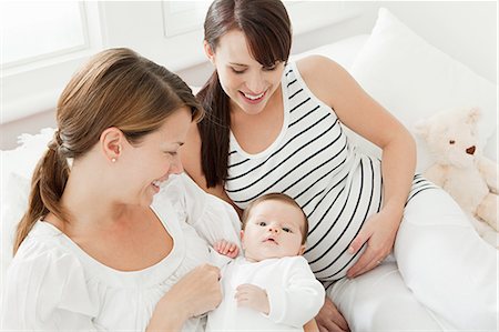 Mother with baby girl and pregnant friend Stock Photo - Premium Royalty-Free, Code: 614-03684132