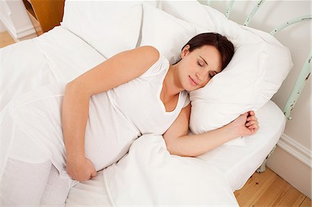 simsearch:649-07521015,k - Pregnant woman asleep in bed Stock Photo - Premium Royalty-Free, Code: 614-03684147