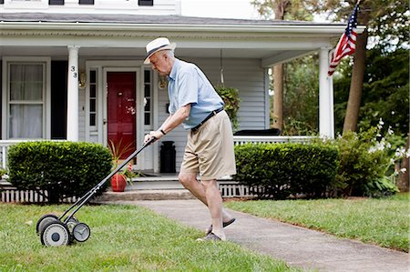 Senior man mowing his front lawn Stock Photo - Premium Royalty-Free, Code: 614-03684745