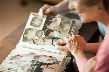 Senior couple looking at family album Stock Photo - Premium Royalty-Free, Code: 614-03684764