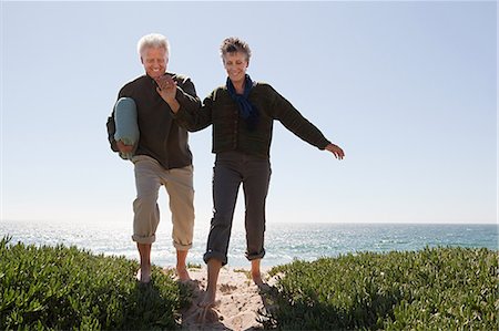 Mature couple walking over dune Stock Photo - Premium Royalty-Free, Code: 614-03697104