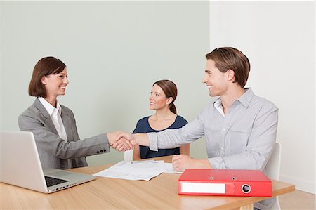 female advisor - Young couple with financial adviser Stock Photo - Premium Royalty-Free, Code: 614-03697201