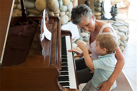 Grandmother and grandson playing the piano Stock Photo - Premium Royalty-Free, Code: 614-03747124