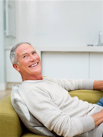 Senior man sitting on sofa Stock Photo - Premium Royalty-Free, Code: 614-03763808