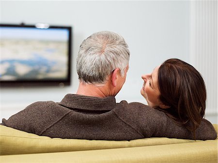 seniors back interior - Mature couple sitting on sofa watching television Stock Photo - Premium Royalty-Free, Code: 614-03763810