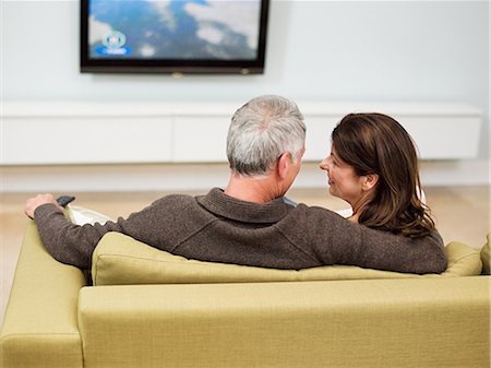 seniors back interior - Mature couple sitting on sofa watching television Stock Photo - Premium Royalty-Free, Code: 614-03763837