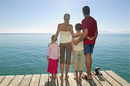 dock family - Rear view of family standing on jetty Stock Photo - Premium Royalty-Free, Code: 614-03783458