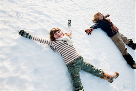 Children making snow angels Stock Photo - Premium Royalty-Free, Code: 614-03903014