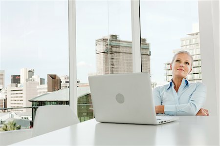 simsearch:6108-06907153,k - Mature businesswoman in office with laptop Stock Photo - Premium Royalty-Free, Code: 614-03981662