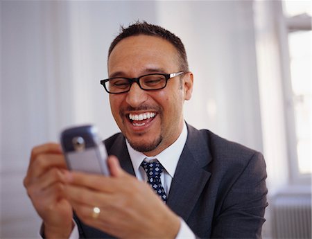 simsearch:6102-07455789,k - A smiling man with a mobile phone. Stock Photo - Premium Royalty-Free, Code: 6102-03748145