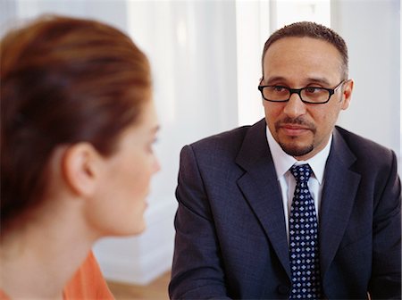 Businessman and woman sitting and having discussion Stock Photo - Premium Royalty-Free, Code: 6102-03859286