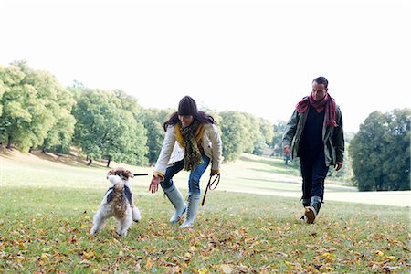 dog stick - A man and a woman playing with a dog in a park an autumn day, Sweden. Stock Photo - Premium Royalty-Free, Code: 6102-03867017