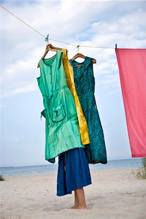 A girl and dresses on a beach, Sweden. Stock Photo - Premium Royalty-Free, Code: 6102-03867410