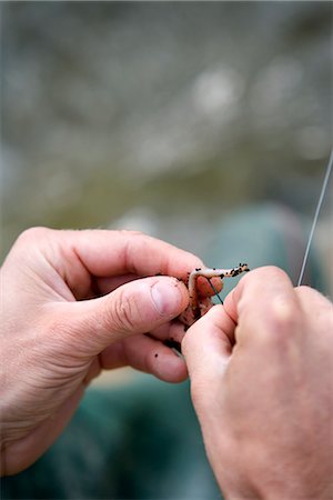 A man with an entangeled  fishing-line, close-up. Stock Photo - Premium Royalty-Free, Code: 6102-03867427