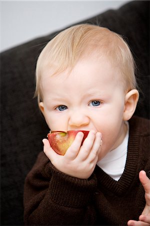 A baby holding an apple, Sweden. Stock Photo - Premium Royalty-Free, Code: 6102-03867764