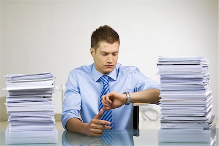 A man with a pile of paper. Stock Photo - Premium Royalty-Free, Code: 6102-03827255