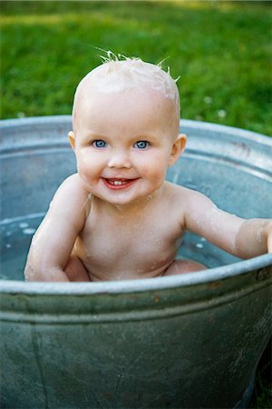 A little girl bathing in a bowl in the garden, Sweden. Stock Photo - Premium Royalty-Free, Code: 6102-03827477