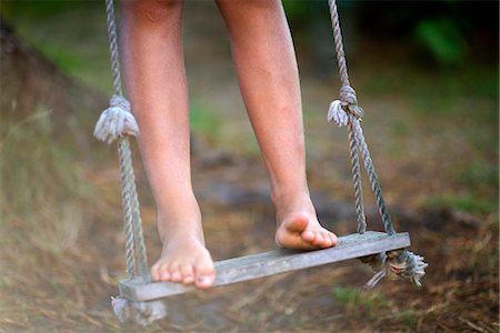 preteen girl feet - A barefoot child on a swing, Sweden. Foto de stock - Sin royalties Premium, Código: 6102-03828334