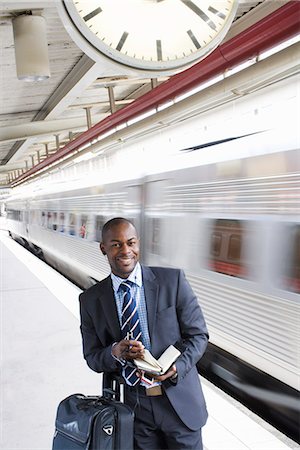 A businessman with a calendar at a train station, Stockholm, Sweden. Stock Photo - Premium Royalty-Free, Code: 6102-03828657