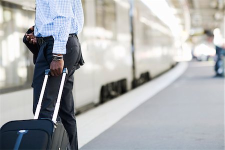 people waiting at train station - A businessman with a bag at a train station, Stockholm, Sweden. Stock Photo - Premium Royalty-Free, Code: 6102-03828634