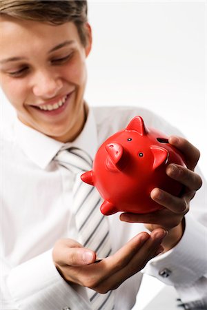 funding - A boy with a piggy bank. Stock Photo - Premium Royalty-Free, Code: 6102-03828776