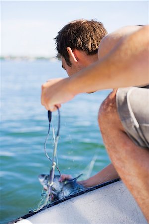 simsearch:6102-08001381,k - A man fishing, Stockholm archipelago, Sweden. Stock Photo - Premium Royalty-Free, Code: 6102-03828937