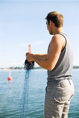 simsearch:6102-08001381,k - A man fishing, Stockholm archipelago, Sweden. Stock Photo - Premium Royalty-Free, Code: 6102-03828938