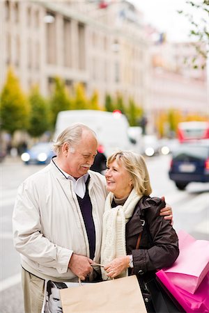 simsearch:6102-06025962,k - A senior couple carrying shopping bags, Stockholm, Sweden. Stock Photo - Premium Royalty-Free, Code: 6102-03829158