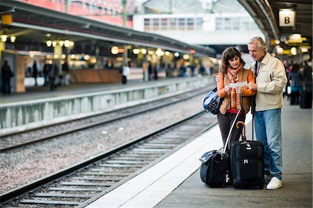 people waiting at train station - A man and woman on a platform at a railway station, Sweden. Stock Photo - Premium Royalty-Free, Code: 6102-03829100
