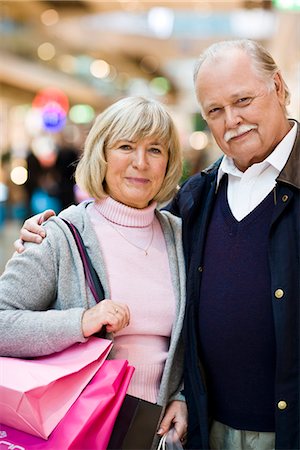 simsearch:6102-06025962,k - Senior couple carrying shopping bags, Stockholm, Sweden. Stock Photo - Premium Royalty-Free, Code: 6102-03829139