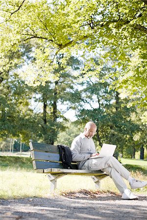 park laptop - Senior man using a laptop in a park, Sweden. Stock Photo - Premium Royalty-Free, Code: 6102-03903969