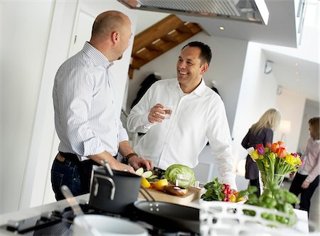 friends cooking inside - Two men making dinner together, Sweden. Stock Photo - Premium Royalty-Free, Code: 6102-03904061