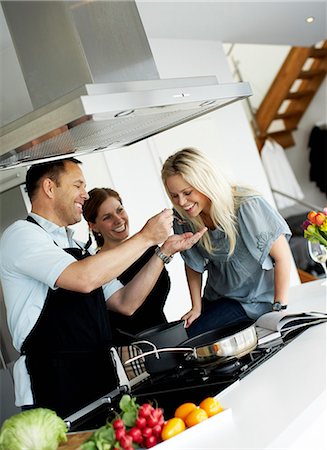 friends cooking inside - Woman tasting dinner, Sweden. Stock Photo - Premium Royalty-Free, Code: 6102-03904072