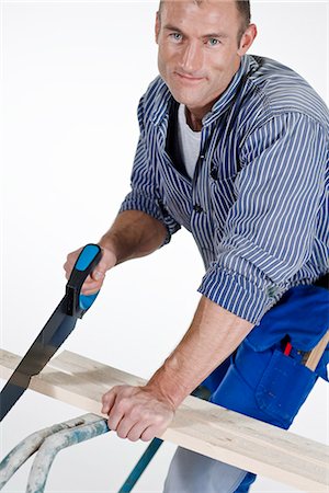 sawing - A joiner using a saw. Stock Photo - Premium Royalty-Free, Code: 6102-03904498