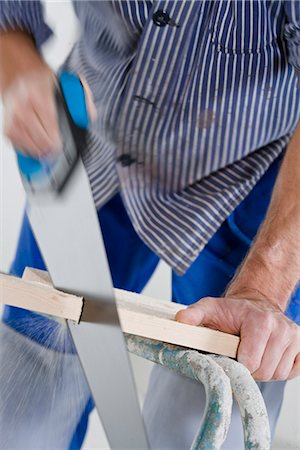 simsearch:6102-07158067,k - A joiner using a saw. Stock Photo - Premium Royalty-Free, Code: 6102-03904499