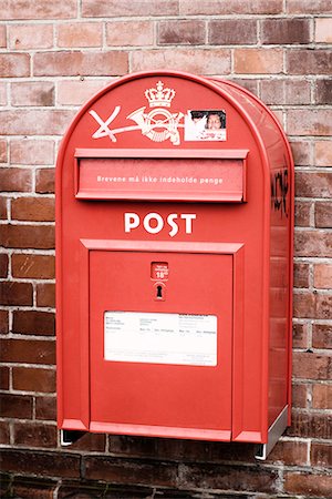 post - A red postbox on a bricked wall, Denmark. Stock Photo - Premium Royalty-Free, Code: 6102-03904978