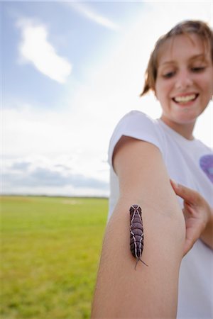Larva crawling on girls arm Stock Photo - Premium Royalty-Free, Code: 6102-03905730