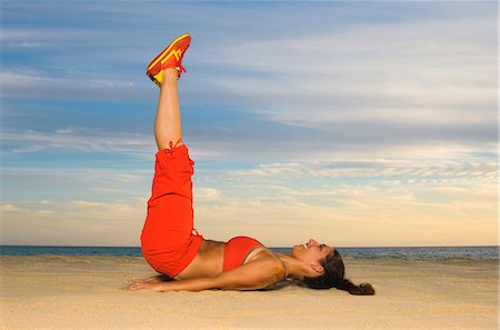 people at portugal beaches - Woman exercising, smiling Stock Photo - Premium Royalty-Free, Code: 6102-03905739