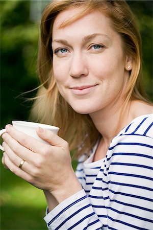 Woman holding coffee cup Stock Photo - Premium Royalty-Free, Code: 6102-03905852